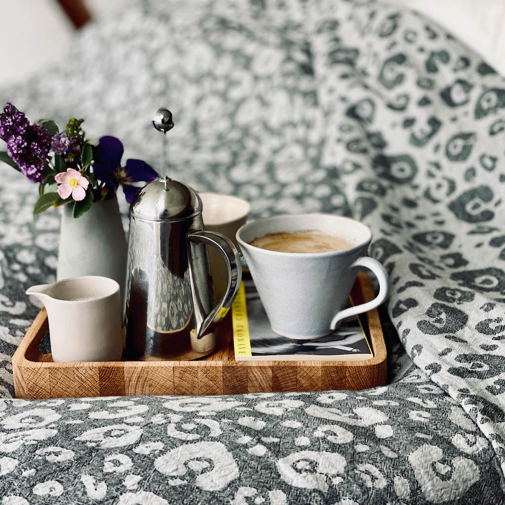 leopard print king size blanket on bed with breakfast tray close up